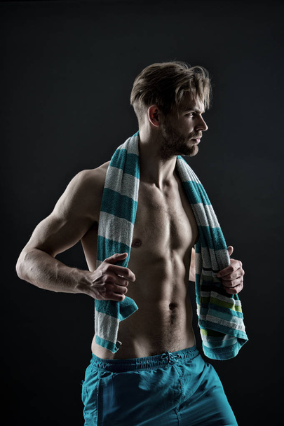 Sportsman with towel after training, hygiene. Bearded man with fit bare chest and belly muscles, health. Sexy macho with six pack, bodycare. Hygiene, health, bodycare, spa, vintage - Foto, imagen