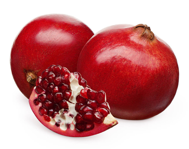 Pomegranate next to fruit lying on its side and section  - Foto, Imagem