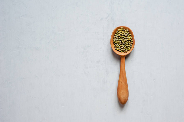 Handmade spoons. One wooden spoon with grains of lentils. - Photo, image