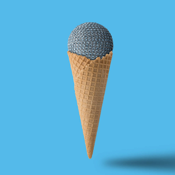 Ice cream cone with christmas ball on bright blue background.  - Valokuva, kuva