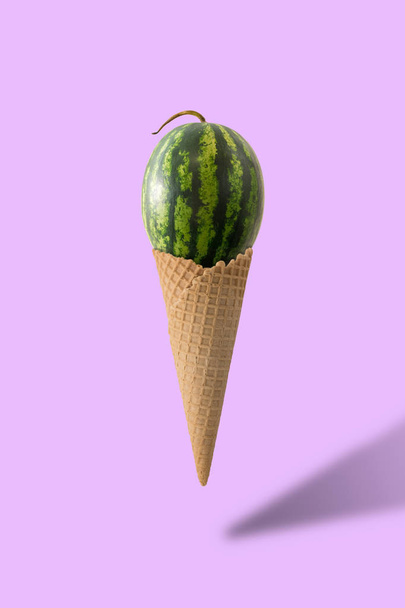 Waffle ice cream cone with watermelon isolated on pink background - Foto, imagen