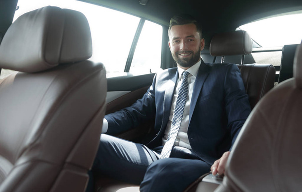 businessman sitting in the back seat of a car - Fotó, kép