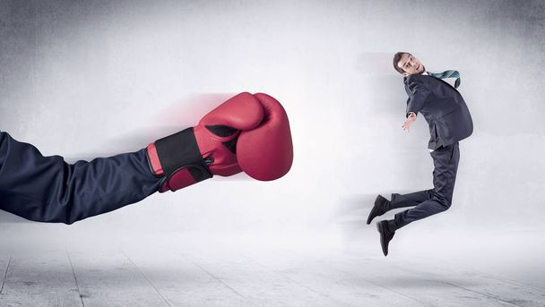 Huge Boxing Gloves punches businessman concept - Foto, afbeelding