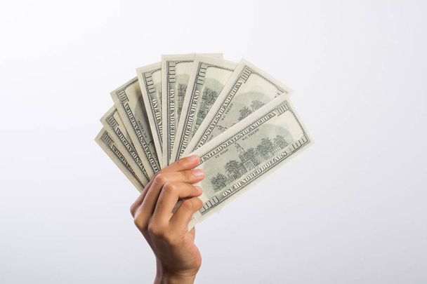 Mano de mujer con dinero aislado sobre fondo blanco
 - Foto, Imagen