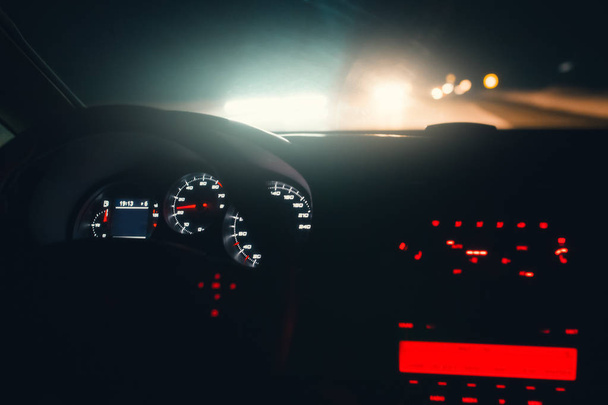 Driving car at night highway. Inside interior view. Illuminated dashboard - 写真・画像