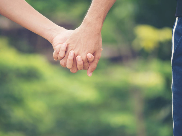 Image of couple holding hands together. - Foto, imagen