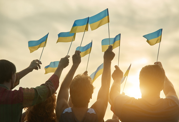 Crowd with ukrainian flags in the evening. - Photo, Image