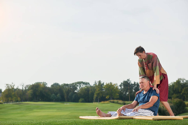 Relaxing thai massage on the park lawn. - 写真・画像
