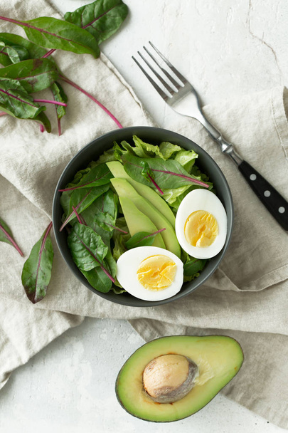 Healthy vegetarian breakfast bowls with salad, avocado and egg, top view. Clean eating, diet food concept - Foto, immagini