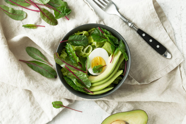 Healthy vegetarian breakfast bowls with salad, avocado and egg, top view. Clean eating, diet food concept - Foto, immagini