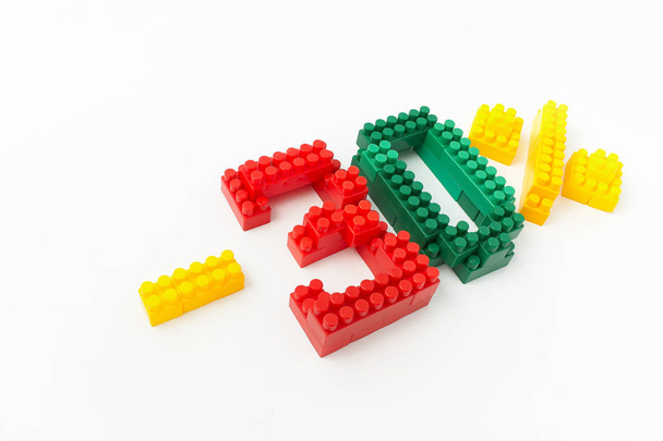 price reduction in percent. a discount. figures from a colored cubes designer on a white background. - Photo, Image