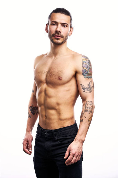 Handsome young shirtless tattooed man posing isolated on white background  - Valokuva, kuva
