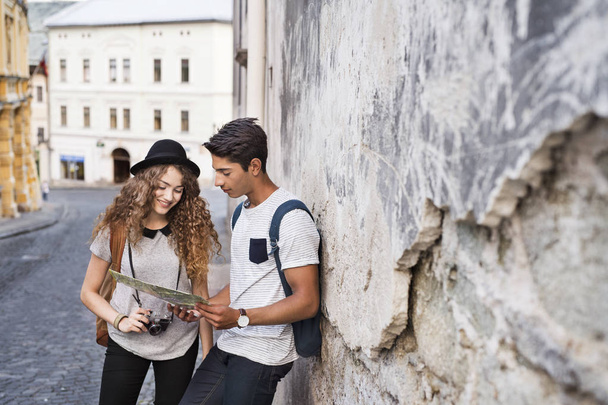 Deux jeunes touristes avec une carte dans la vieille ville
. - Photo, image