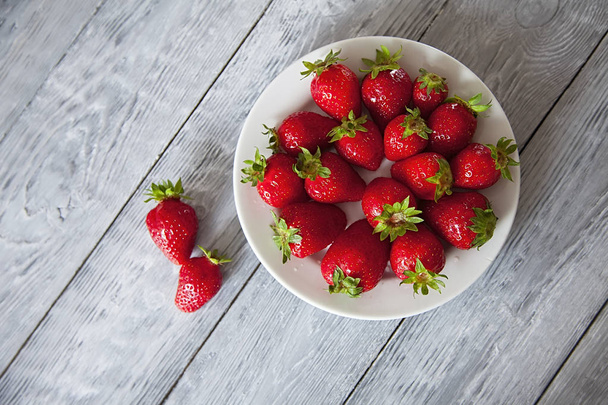 Fresh strawberries on old wooden background - Photo, Image