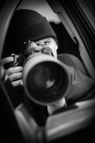 Paparazzi, Young and attractive man taking photographs with his dslr camera - Valokuva, kuva