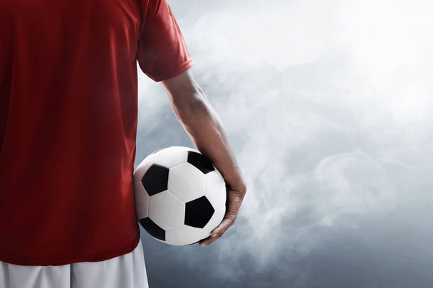 Soccer player holding soccer ball - Фото, изображение