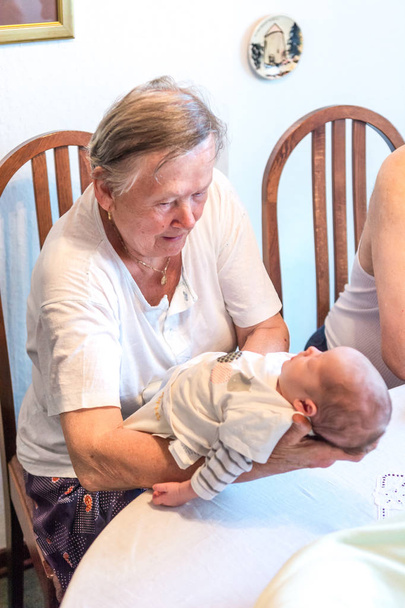 Happy grandmother caressing newborn baby. - Photo, Image