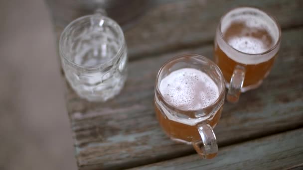 Rastreamento lento tiro sobre o topo de cervejas recém-derramadas em uma mesa de jardim pub
 - Filmagem, Vídeo