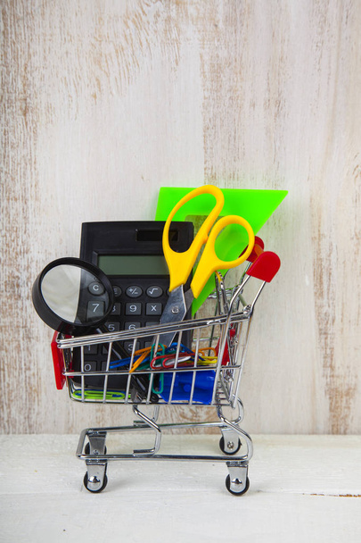 Items for school in a shopping trolley - Foto, Imagem