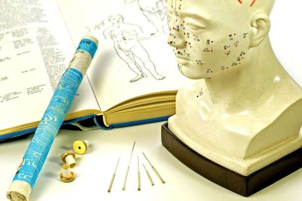 Acupuncture needles, head model, textbook and moxa roll - Photo, Image