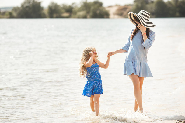 Mother with daughter having fun in water - Photo, Image