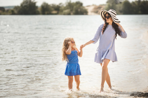 Mother with daughter having fun in water - Photo, Image