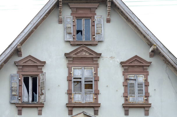 Τέλος αετωμάτων και τα παράθυρα του ένα παλιό εγκαταλελειμμένο σπίτι - Φωτογραφία, εικόνα