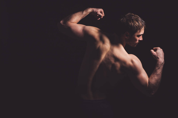 back view image of sportsmen displaying development of muscles - Foto, Imagem