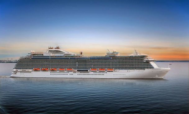 Luxury cruise ship sailing from port on sunset  - 写真・画像