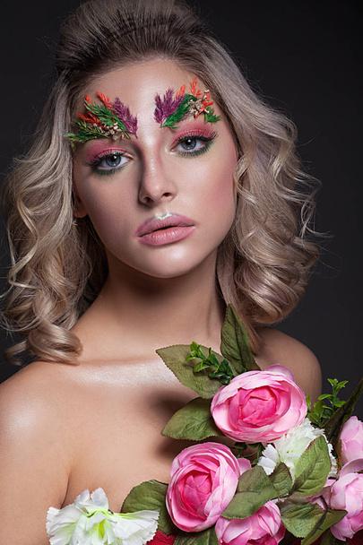Portrait of a beautiful girl with creative make-up and hairstyle - Photo, image