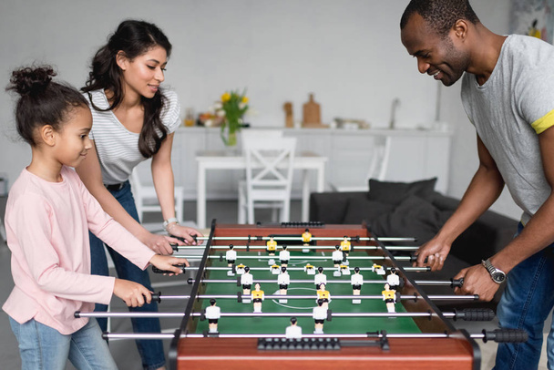 happy young family playing table football together at home - Photo, Image