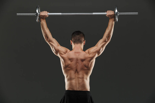 Back view of a fit muscular bodybuilder - Φωτογραφία, εικόνα