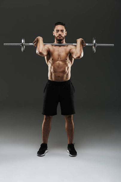 Portrait of a serious muscular bodybuilder - Фото, изображение