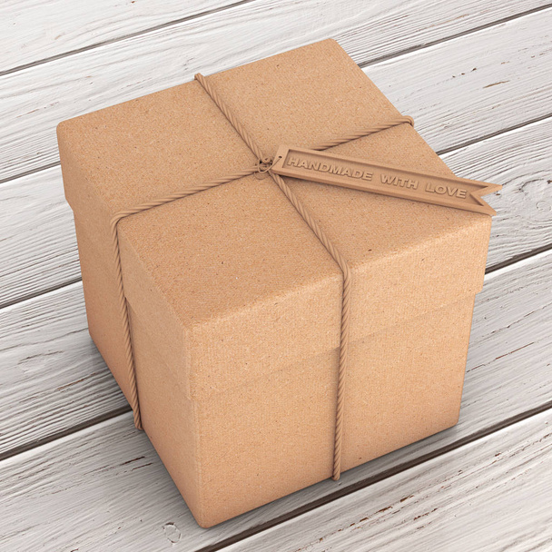 Boîte cadeau en carton avec corde et étiquette artisanale en bois avec main
  - Photo, image