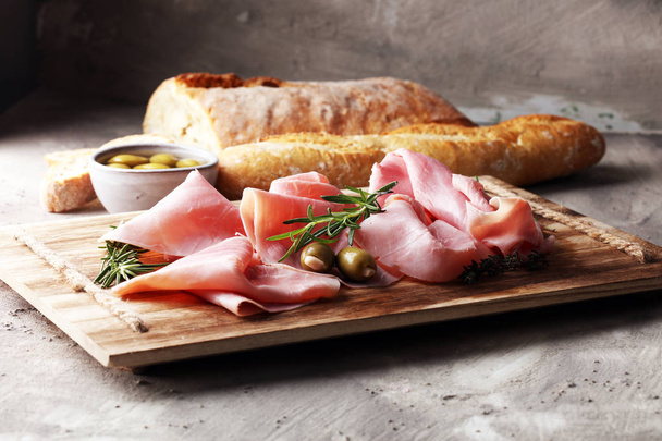 Sliced ham on wooden board. Fresh prosciutto. Pork ham sliced. - Photo, Image