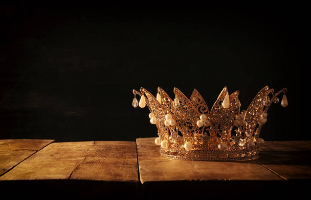 low key image of beautiful queen/king crown over wooden table. vintage filtered. fantasy medieval period. - Photo, Image