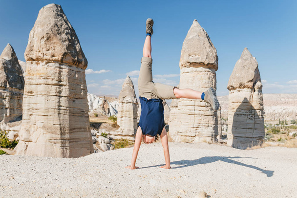 Genç kadının Kapadokya Vadisi bazı akrobatik yoga egzersizleri yapması - Fotoğraf, Görsel