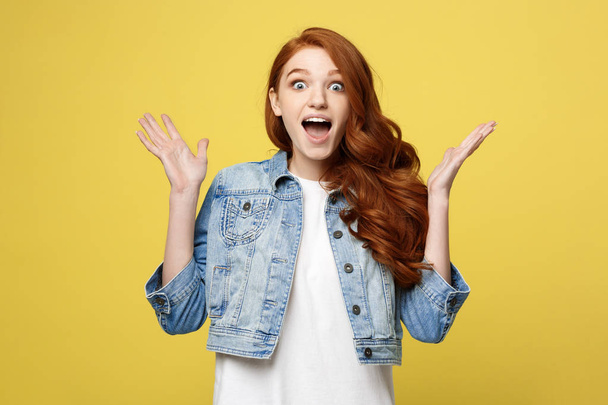 Surprised red hair teenage girl show shocking expression with something. Isolated on Bright Yellow Background. Copy space. - Fotografie, Obrázek