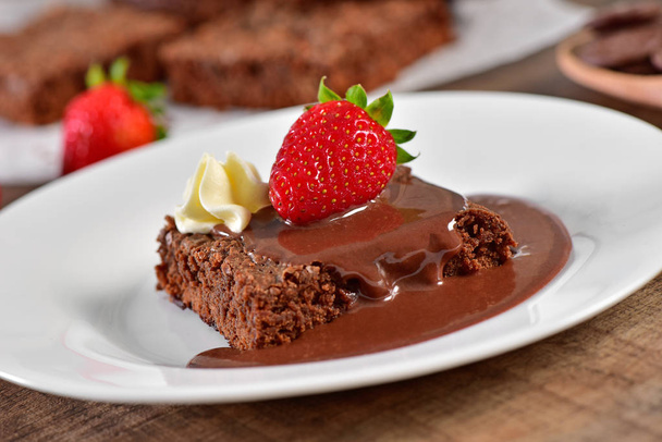 Brownie with chocolate sauce and strawberry - Photo, Image