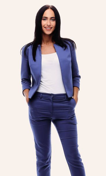 Confident young businesswoman standing with hands in pocket - Foto, afbeelding