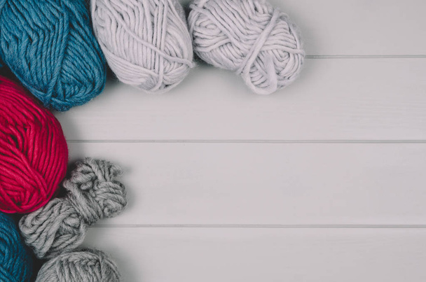 Knitting background with wool balls on gray wooden table - Φωτογραφία, εικόνα