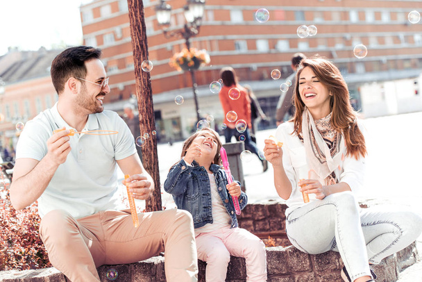 Parents and girl having great time in city - Fotoğraf, Görsel