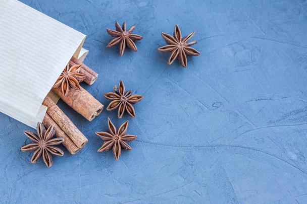 Cinnamon and star anise in paper bag top view - Fotó, kép