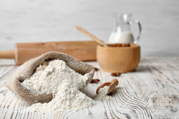 Sack with flour on wooden table - Photo, Image