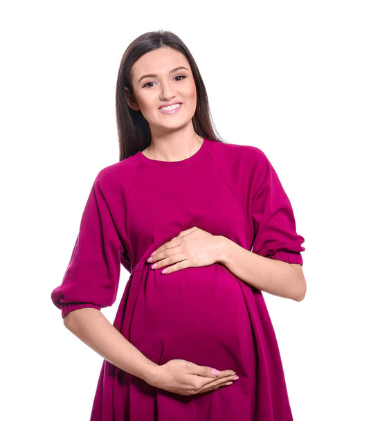 Young pregnant woman in casual clothes on white background - Fotografie, Obrázek