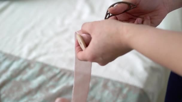 Young woman cutting pink ribbo - Video, Çekim