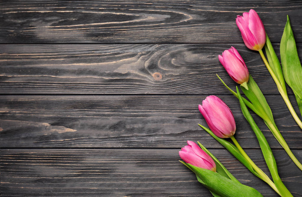 Beautiful fresh tulips on wooden background - Фото, изображение