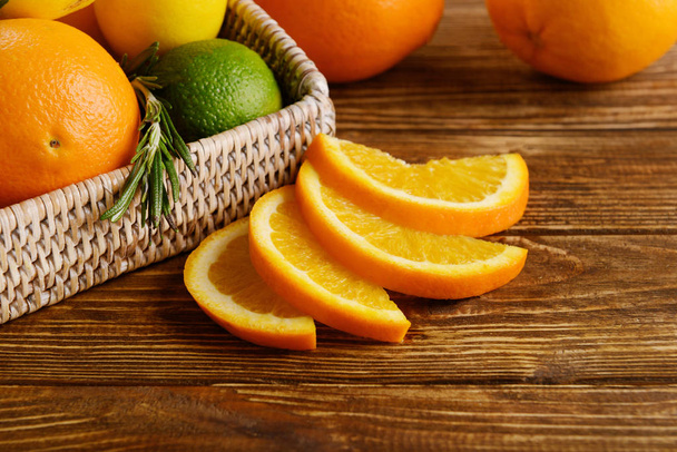 Tray with ripe citrus fruits on wooden background - Photo, Image
