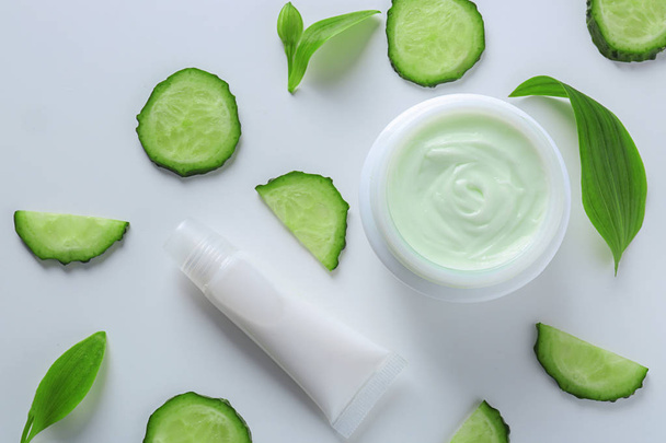 Composition with body cream and cucumber slices on white background - Fotografie, Obrázek