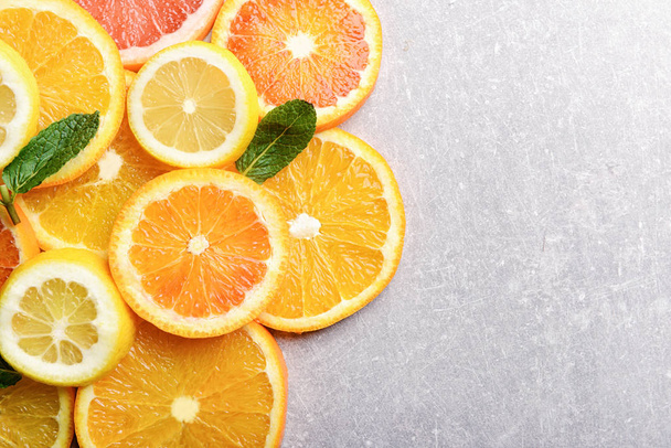 Many citrus slices on gray background, top view - Photo, Image